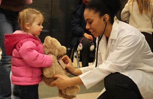 Young girl with teddy bear at ZooAmerica